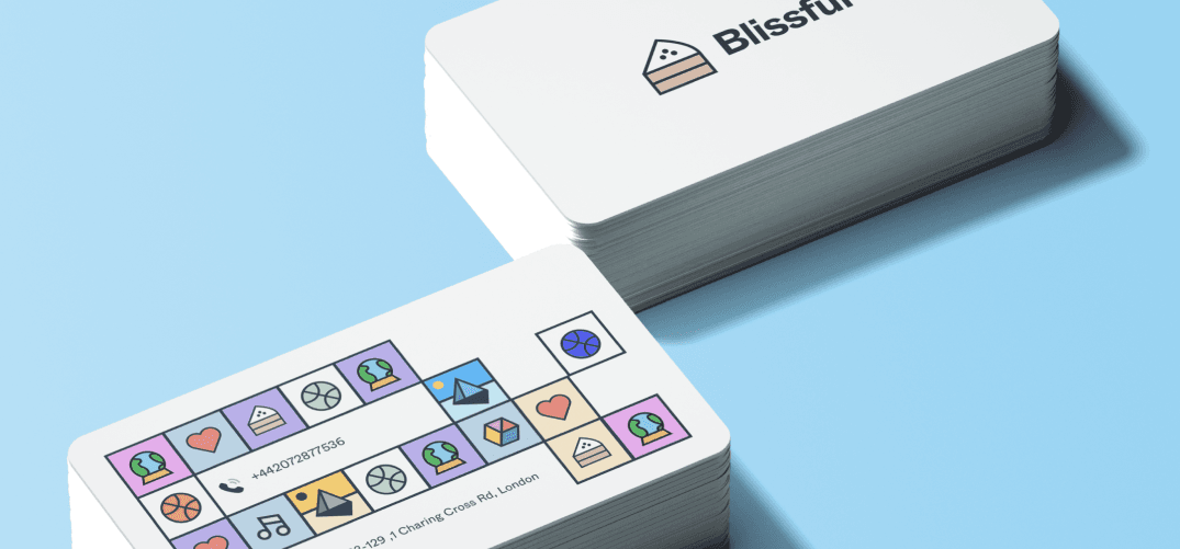 A stack of business cards: the logo on the front, a strip of tiles around the contact details on the back.
