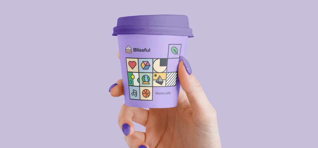 A hand holding a lilac cup labelled Mocha Latte, the tiles covering most of the front.