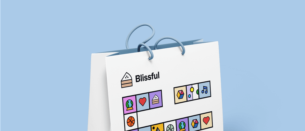 A white Blissful shopping bag with the cake-slice logo and a row of colourful icon tiles, on pale blue.