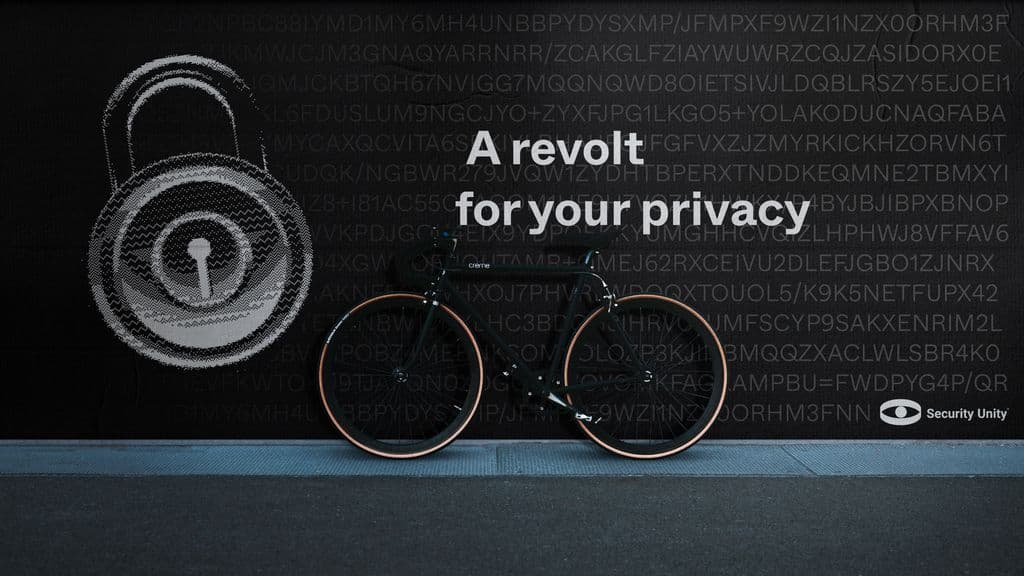 A Security Unity billboard reading "A revolt for your privacy": a padlock drawn in text over a bicycle against a dark wall of code.