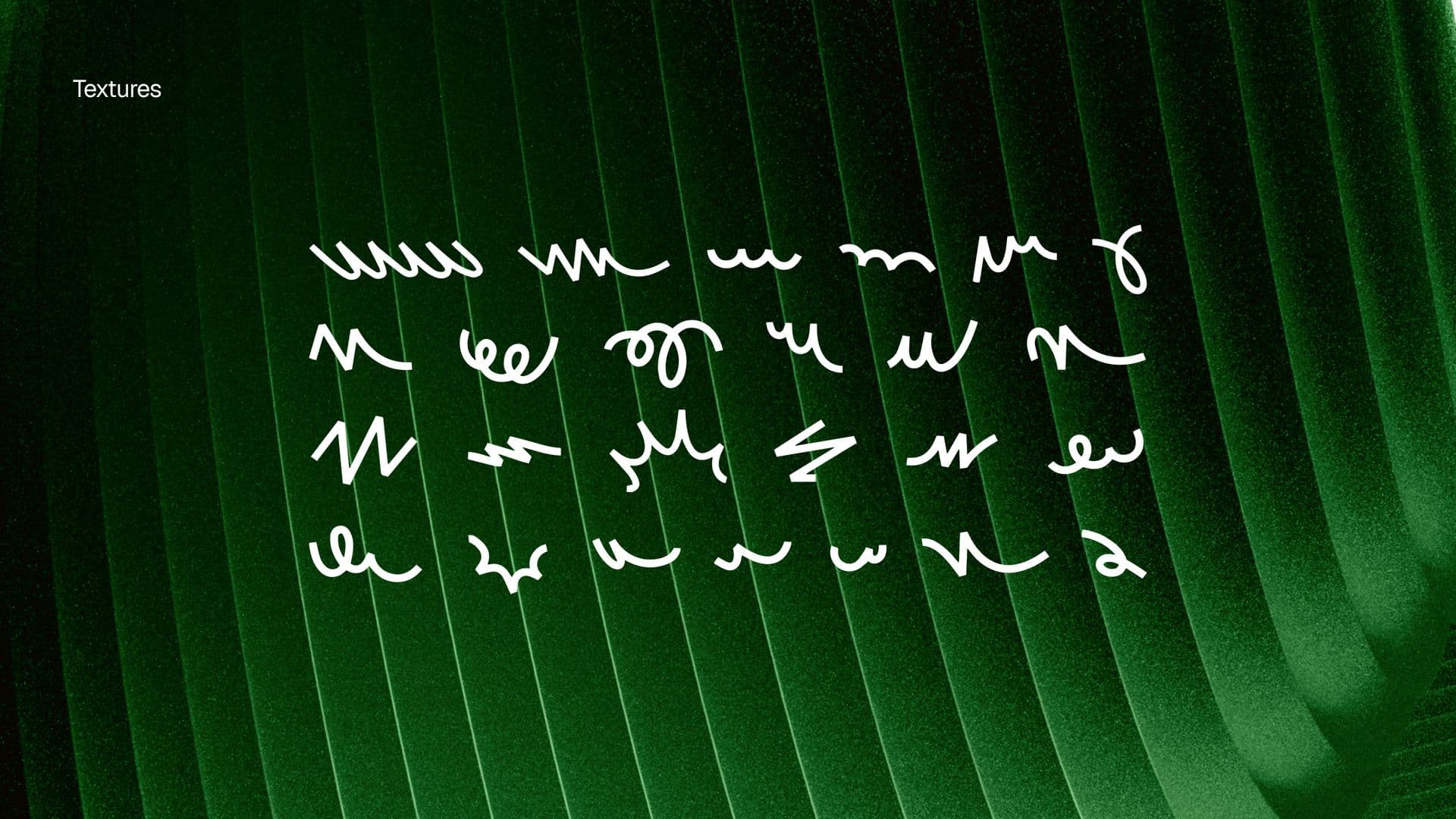 Rows of hand-drawn loops and squiggles in white, over dark green ribbed folds.